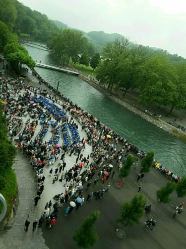 A crowded grotto, Lourdes.